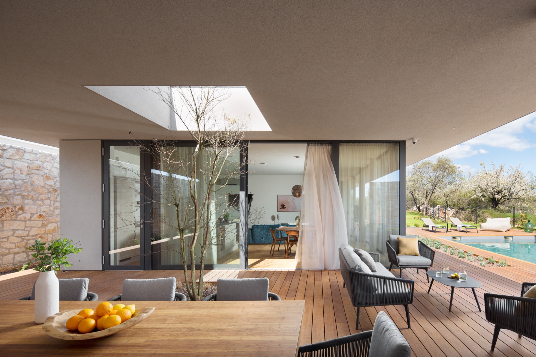 Covered terrace with poolside views