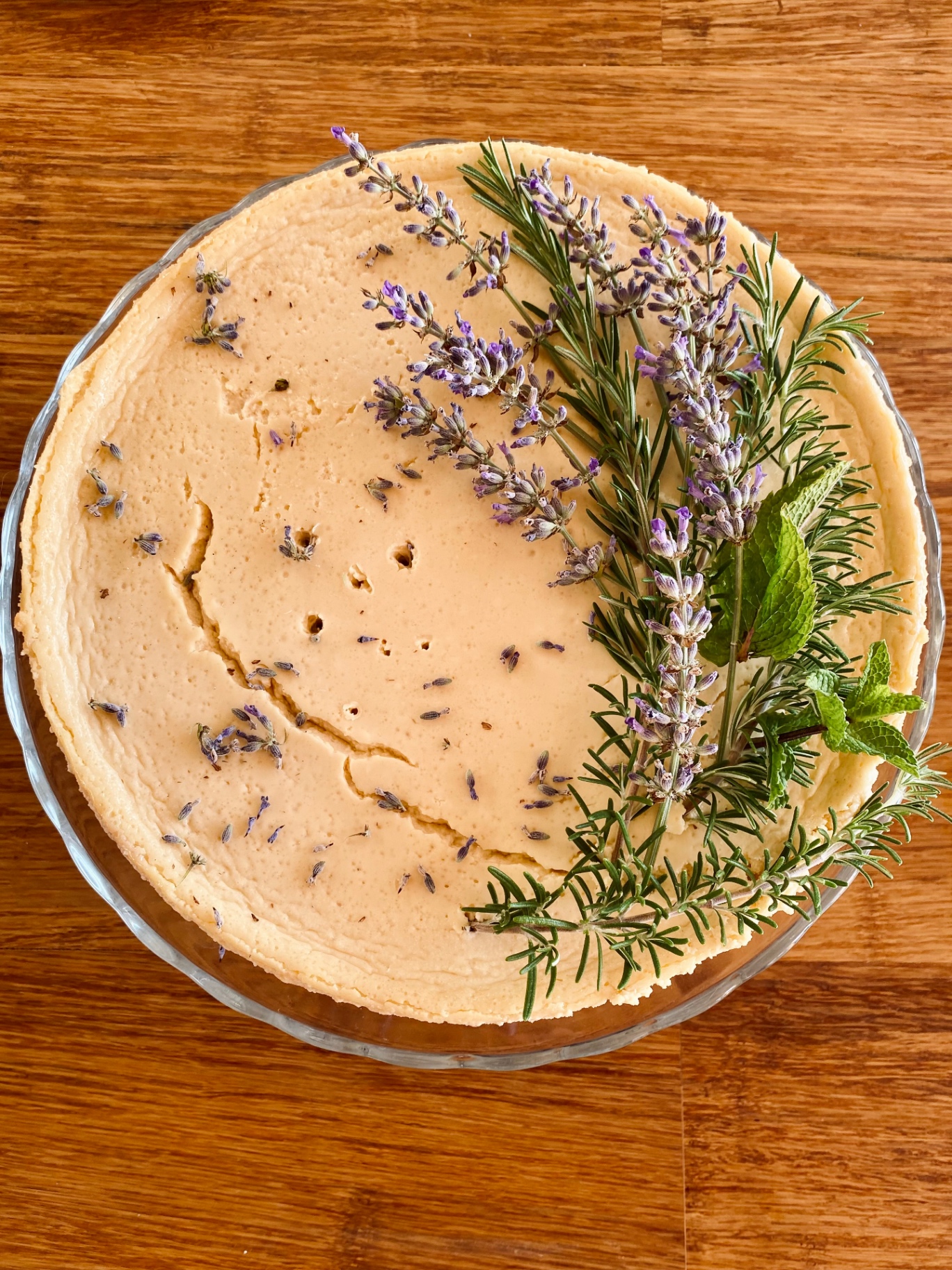 Lavender and herb cheesecake garnished with rosemary and mint